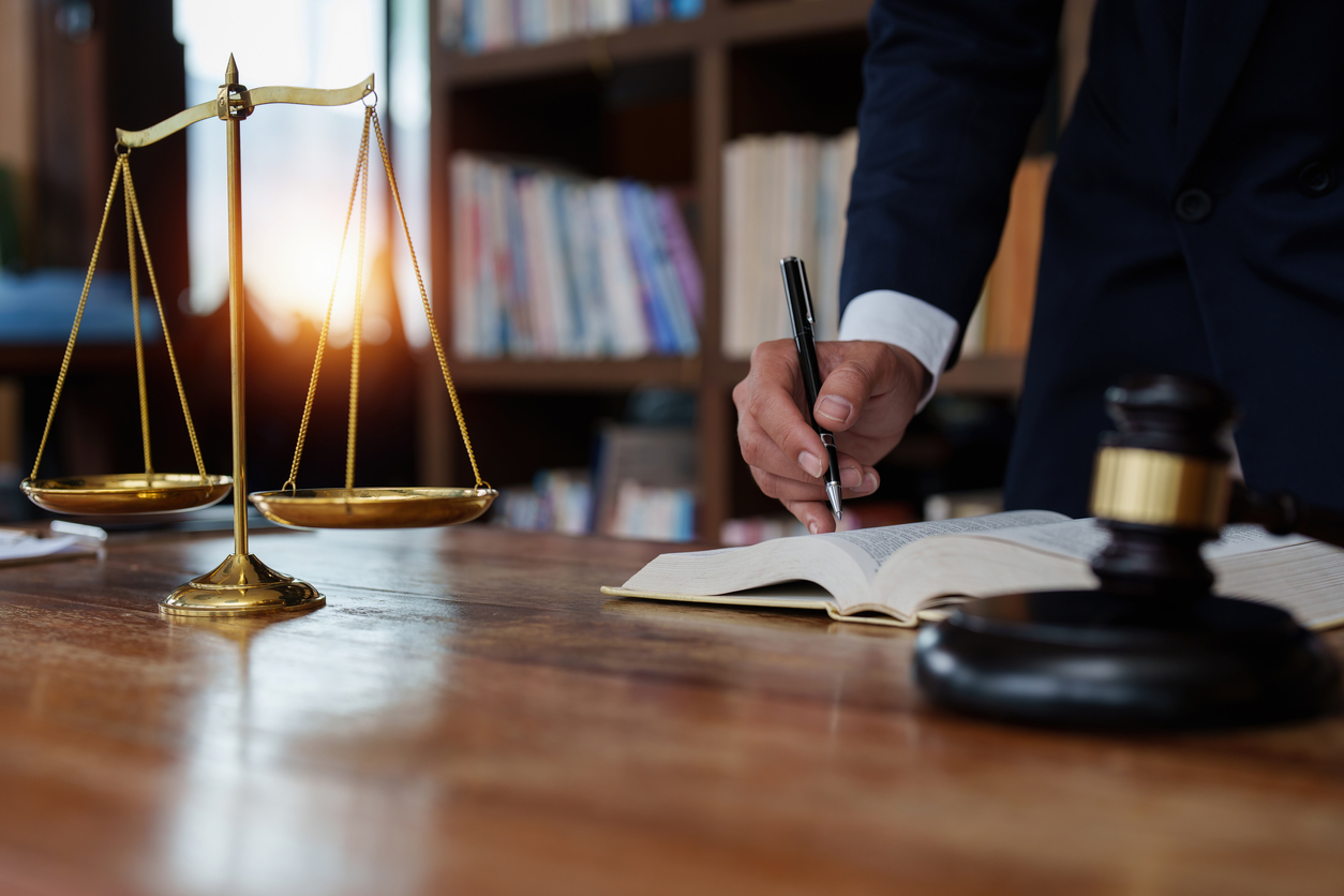 Close up lawyer businessman working or reading lawbook in office workplace for consultant lawyer concept